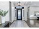 Elegant entryway with decorative front door, side windows, and modern light fixture at 3842 E Alameda Ln, Gilbert, AZ 85298