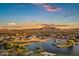 Panoramic sunset aerial view of a community golf course and mountain views at 3842 E Alameda Ln, Gilbert, AZ 85298