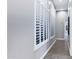 Hallway with white wood shutters and grey walls which provide natural light and a view outside at 3842 E Alameda Ln, Gilbert, AZ 85298