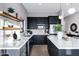 Stylish kitchen featuring a u-shaped layout with white countertops, stainless steel appliances and dark cabinets at 3842 E Alameda Ln, Gilbert, AZ 85298