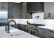 Gourmet kitchen featuring premium appliances, gray cabinets, and quartz countertops at 3842 E Alameda Ln, Gilbert, AZ 85298