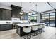 Modern kitchen with an expansive island, stylish pendant lights, and sleek cabinets at 3842 E Alameda Ln, Gilbert, AZ 85298