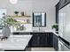 Modern kitchen featuring dark cabinetry, white marble countertops, open shelving, and stainless steel appliances at 3842 E Alameda Ln, Gilbert, AZ 85298