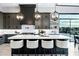 Beautiful kitchen with white marble island, stylish light fixtures, and modern dark grey cabinets at 3842 E Alameda Ln, Gilbert, AZ 85298