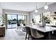 Open-concept living area with a view of the pool through large windows, seamlessly connecting indoor and outdoor spaces at 3842 E Alameda Ln, Gilbert, AZ 85298