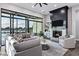 Comfortable living room boasts a stone fireplace, large windows with a beautiful view, and modern decor at 3842 E Alameda Ln, Gilbert, AZ 85298