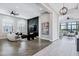 Open-concept living room with gray walls, wood flooring, and modern furnishings at 3842 E Alameda Ln, Gilbert, AZ 85298