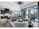 A grand living room with large windows, seamlessly connecting to the kitchen and outdoor patio spaces at 3842 E Alameda Ln, Gilbert, AZ 85298