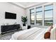 Well-lit bedroom featuring a dark cabinet, a ceiling fan, and waterfront views at 3842 E Alameda Ln, Gilbert, AZ 85298