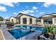 Stunning backyard pool area with lounge chairs, lush plants, and a spacious patio for entertaining at 3842 E Alameda Ln, Gilbert, AZ 85298