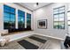 Bright workout space featuring large windows, built-in bench, and modern wood-look flooring at 3842 E Alameda Ln, Gilbert, AZ 85298