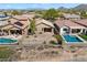 Aerial view of desert landscaped backyard, with a neighborhood swimming pool at 40055 N High Noon Way, Anthem, AZ 85086