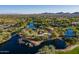 Scenic aerial view of community park with ponds, playground and green spaces and mountain backdrop at 40055 N High Noon Way, Anthem, AZ 85086