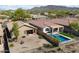 Desert landscaped yards featuring pools and covered patios in a quiet community at 40055 N High Noon Way, Anthem, AZ 85086
