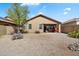 Gravel backyard with desert plants, view of covered patio, and block fence at 40055 N High Noon Way, Anthem, AZ 85086