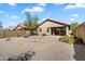 Spacious backyard features gravel landscaping, desert plants, and block wall fencing at 40055 N High Noon Way, Anthem, AZ 85086