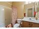 Bright bathroom featuring a tub with shower, a white toilet, and a wood vanity with sink at 40055 N High Noon Way, Anthem, AZ 85086