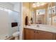 Bathroom featuring a standing shower, toilet, sink and lots of mirror space at 40055 N High Noon Way, Anthem, AZ 85086