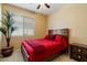 Bedroom with hardwood bed frame, potted plant, and natural lighting at 40055 N High Noon Way, Anthem, AZ 85086