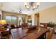 Cozy dining room with a wooden table set, chandelier, and a view into the living area and backyard at 40055 N High Noon Way, Anthem, AZ 85086