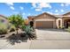 Charming single-story home with a well-manicured desert landscape and a two-car garage at 40055 N High Noon Way, Anthem, AZ 85086