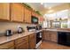 Bright kitchen with wooden cabinets, standard appliances, and neutral countertops at 40055 N High Noon Way, Anthem, AZ 85086