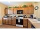 Traditional kitchen with wooden cabinets and essential appliances, ideal for cooking at 40055 N High Noon Way, Anthem, AZ 85086