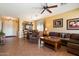 Warm living room with tile floors, comfortable seating, and ample natural light at 40055 N High Noon Way, Anthem, AZ 85086