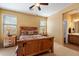 Main bedroom features a decorative bed, two windows, and ensuite bathroom at 40055 N High Noon Way, Anthem, AZ 85086
