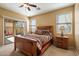 Main bedroom features a decorative bed, sliding glass doors to patio, and comfortable space at 40055 N High Noon Way, Anthem, AZ 85086