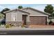 Inviting single-story home featuring a two-car garage and charming desert landscaping at 4166 W Lisa Ln, San Tan Valley, AZ 85144
