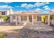 Charming home boasts a covered patio, low maintenance backyard and stone pathway for easy access at 4446 E Woodridge Dr, Phoenix, AZ 85032