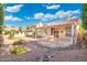 Expansive backyard with covered patio and desert landscaping, ideal for outdoor living at 4446 E Woodridge Dr, Phoenix, AZ 85032
