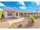 Beautiful home exterior with covered patio, well-manicured landscaping and a lush green lawn at 4446 E Woodridge Dr, Phoenix, AZ 85032