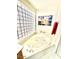 Stylish bathroom featuring a luxurious soaking tub with tiled surround at 4446 E Woodridge Dr, Phoenix, AZ 85032