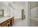 Bathroom with dual sinks, tub, shower and storage shelves at 4446 E Woodridge Dr, Phoenix, AZ 85032