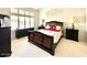 Comfortable carpeted bedroom with natural light from a large window and classic decor at 4446 E Woodridge Dr, Phoenix, AZ 85032