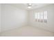 Bright bedroom features neutral carpet, ceiling fan and window with shutters for optimal privacy at 4446 E Woodridge Dr, Phoenix, AZ 85032