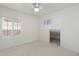 Bright bedroom featuring neutral carpet and two windows with plantation shutters at 4446 E Woodridge Dr, Phoenix, AZ 85032
