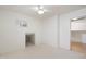 Bedroom with neutral carpet, small window, and a view of another room at 4446 E Woodridge Dr, Phoenix, AZ 85032
