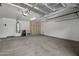 Spacious garage offers ample room for storage and vehicles. Features utility access and painted floor at 4446 E Woodridge Dr, Phoenix, AZ 85032