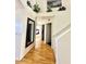 Inviting hallway with wood flooring, elegant staircase, decorative accents, and seamless flow into the rooms at 4446 E Woodridge Dr, Phoenix, AZ 85032