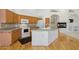Well-equipped kitchen with an island, wood cabinets, and modern appliances at 4446 E Woodridge Dr, Phoenix, AZ 85032