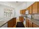 Bright kitchen features wood cabinets, granite countertops, and tile backsplash at 4446 E Woodridge Dr, Phoenix, AZ 85032