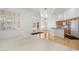 Open-concept living space flows into the kitchen, featuring shutters, hardwood floors, and modern appliances at 4446 E Woodridge Dr, Phoenix, AZ 85032
