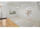 Bright and airy living room with large windows, ceiling fan, and neutral carpeting at 4446 E Woodridge Dr, Phoenix, AZ 85032