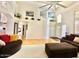 Open-concept living area with hardwood floors, a cozy sofa and lots of natural light at 4446 E Woodridge Dr, Phoenix, AZ 85032