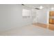 Open living area with neutral carpet and a view of stairs and cabinets at 4446 E Woodridge Dr, Phoenix, AZ 85032