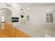 Spacious living room featuring a fireplace, arched doorways, and plenty of natural light at 4446 E Woodridge Dr, Phoenix, AZ 85032