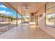 Enjoy this covered patio with ceiling fan, screens and serene backyard view. A great space for entertaining at 4446 E Woodridge Dr, Phoenix, AZ 85032